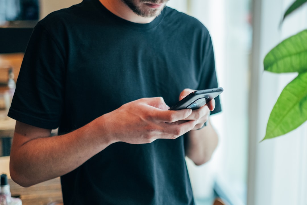 Person using mobile device in modern setting